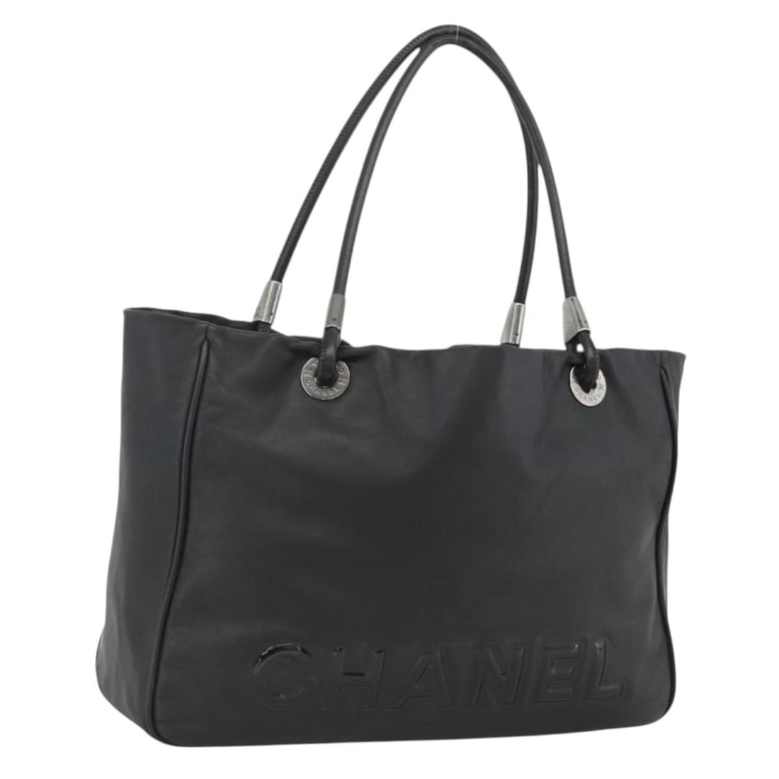 Chanel Black Lambskin Camelia Tote with Silver CC Logo: Chanel Black Lambskin Camelia Tote with Silver CC Logo This CHANEL Camelia tote bag is crafted from black lambskin and features silver-tone CC accents. Designed for women, this tote offers a spacious