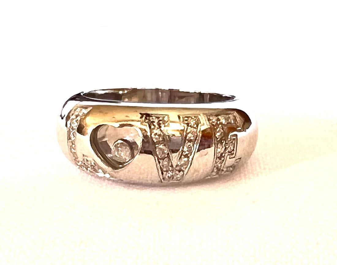 Chopard Swiss Love 18K White Gold Diamond Ring with Box 6.75: Chopard Swiss Love 18K White Gold Diamond Ring with Box 6.75 This exquisite Chopard Swiss Love ring is crafted from 18K white gold and adorned with approximately 0.25 ct of GVS diamonds. Measuring siz