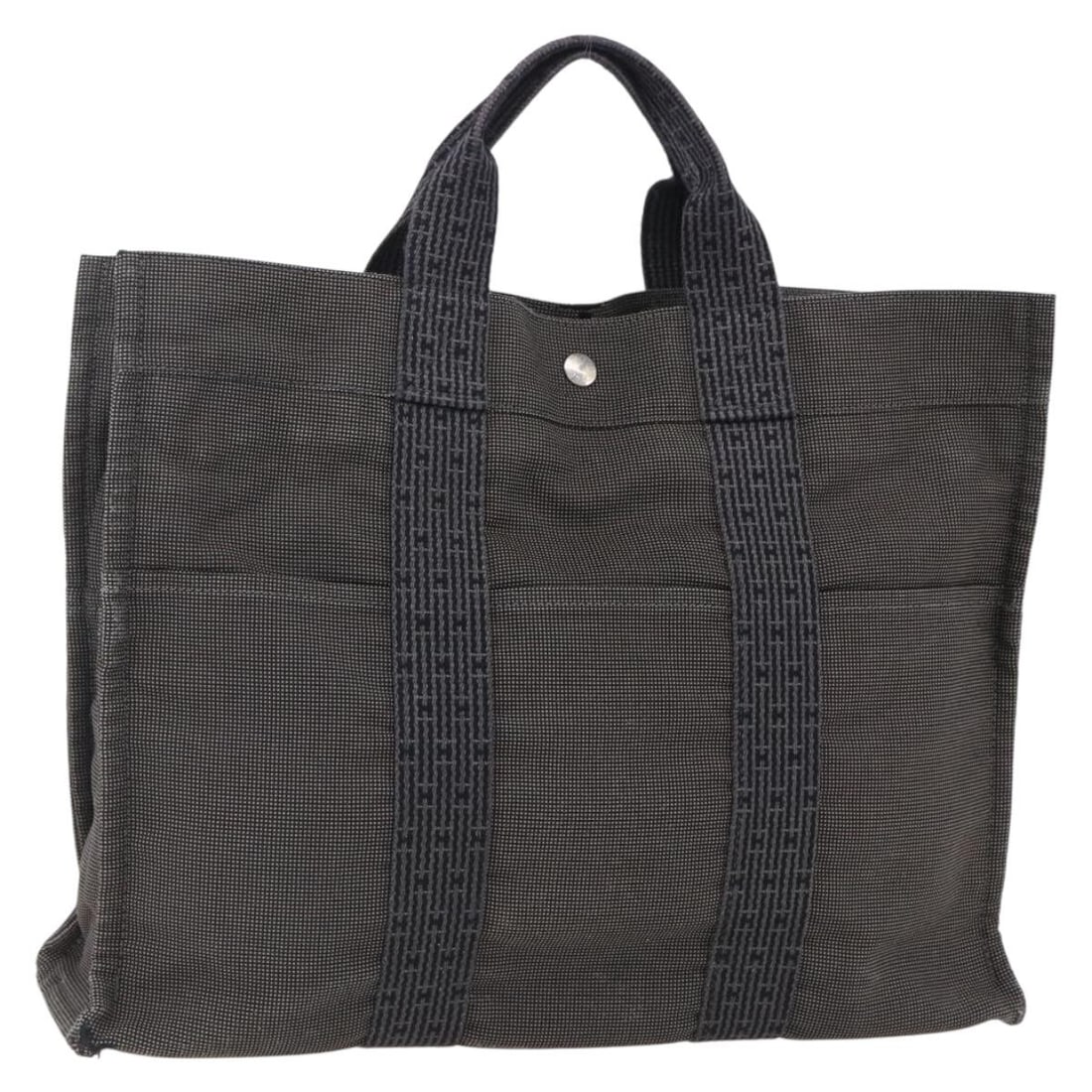 Her Line MM Canvas Tote Bag by Hermes in Gray: Her Line MM Canvas Tote Bag by Hermes in Gray This Hermes Her Line Tote MM handbag is crafted from gray canvas and features a spacious main compartment with a top handle design. Made in France, the ba
