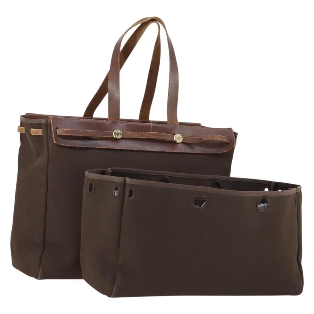 Herbag Cabas MM Canvas and Leather Tote in Gold Brown by Hermes: Herbag Cabas MM Canvas and Leather Tote in Gold Brown by Hermes This Hermes Herbag Cabas MM hand bag is crafted from canvas with leather accents and features a gold and brown color scheme. The bag is