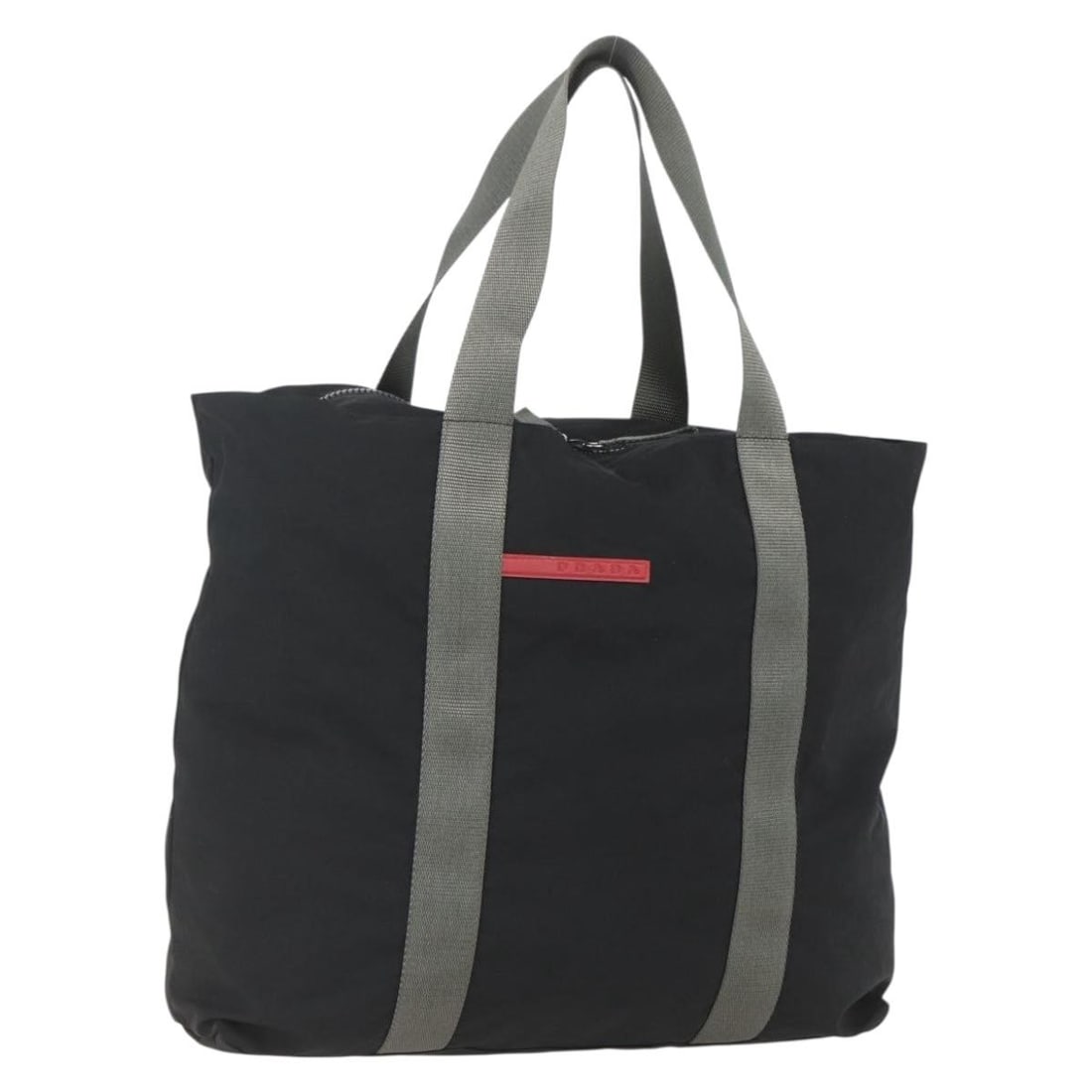 Black Nylon Prada Sports Series Italian Handbag with Silver Accents: Black Nylon Prada Sports Series Italian Handbag with Silver Accents This Prada Sports hand bag is crafted from black and silver nylon and features a spacious interior. Made in Italy, it has a handle d