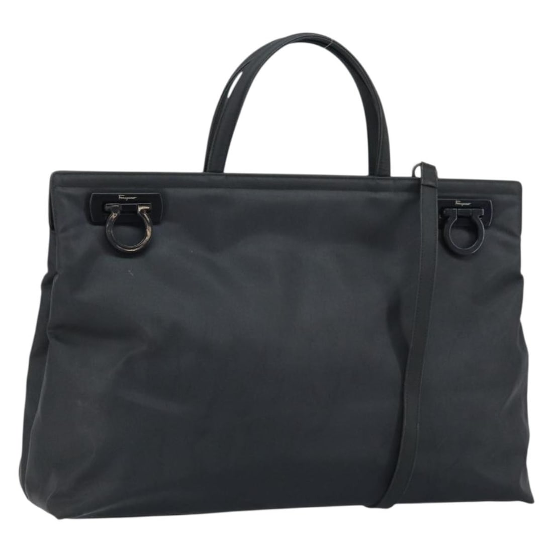 Black Nylon Salvatore Ferragamo Gancini Convertible Handbag with Silver Accents: Black Nylon Salvatore Ferragamo Gancini Convertible Handbag with Silver Accents This Salvatore Ferragamo Gancini handbag is crafted from black nylon with silver-tone accents. Designed as a 2-way bag,