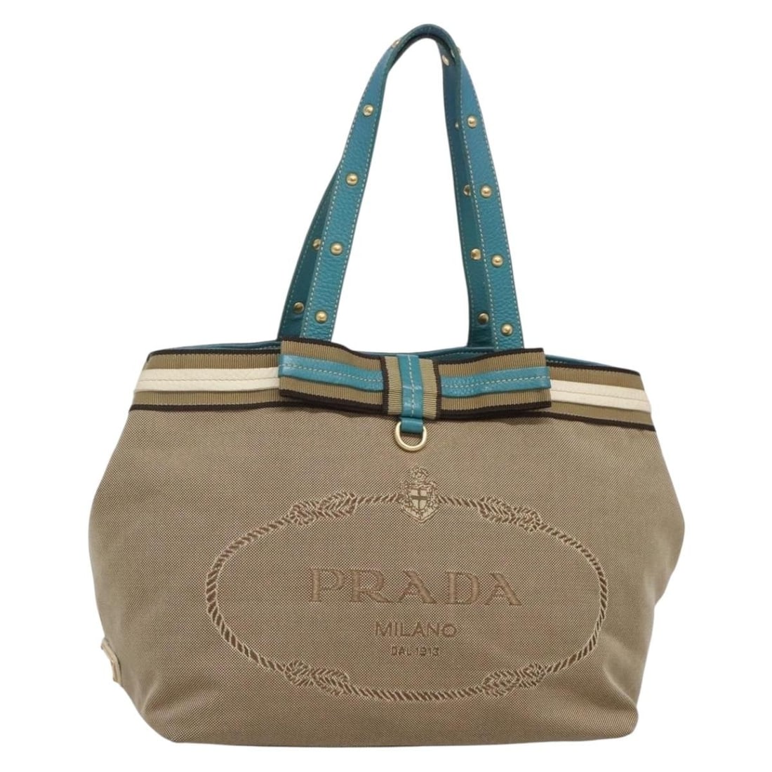 PRADA Beige Gold Studs Tote Bag Canvas Auth 141984V Italy: PRADA Beige Gold Studs Tote Bag Canvas Auth 141984V Italy Presenting a stylish PRADA Tote Bag, masterfully crafted from durable canvas in a chic beige and gold color scheme. This elegant accessory fea