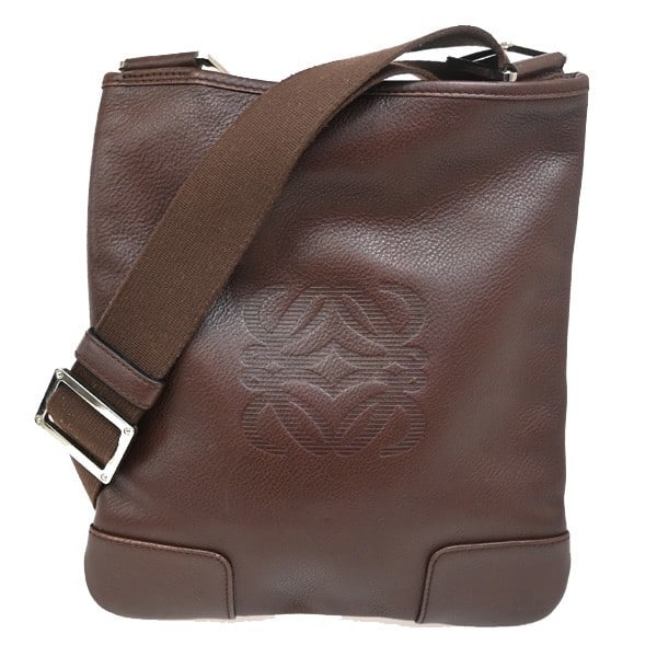 Loewe Brown Leather Anagram Shoulder Bag for Women: Loewe Brown Leather Anagram Shoulder Bag for Women This Loewe Anagram Shoulder Bag features a brown leather exterior and is designed for women. The bag is pre-owned and shows noticeable signs of use,