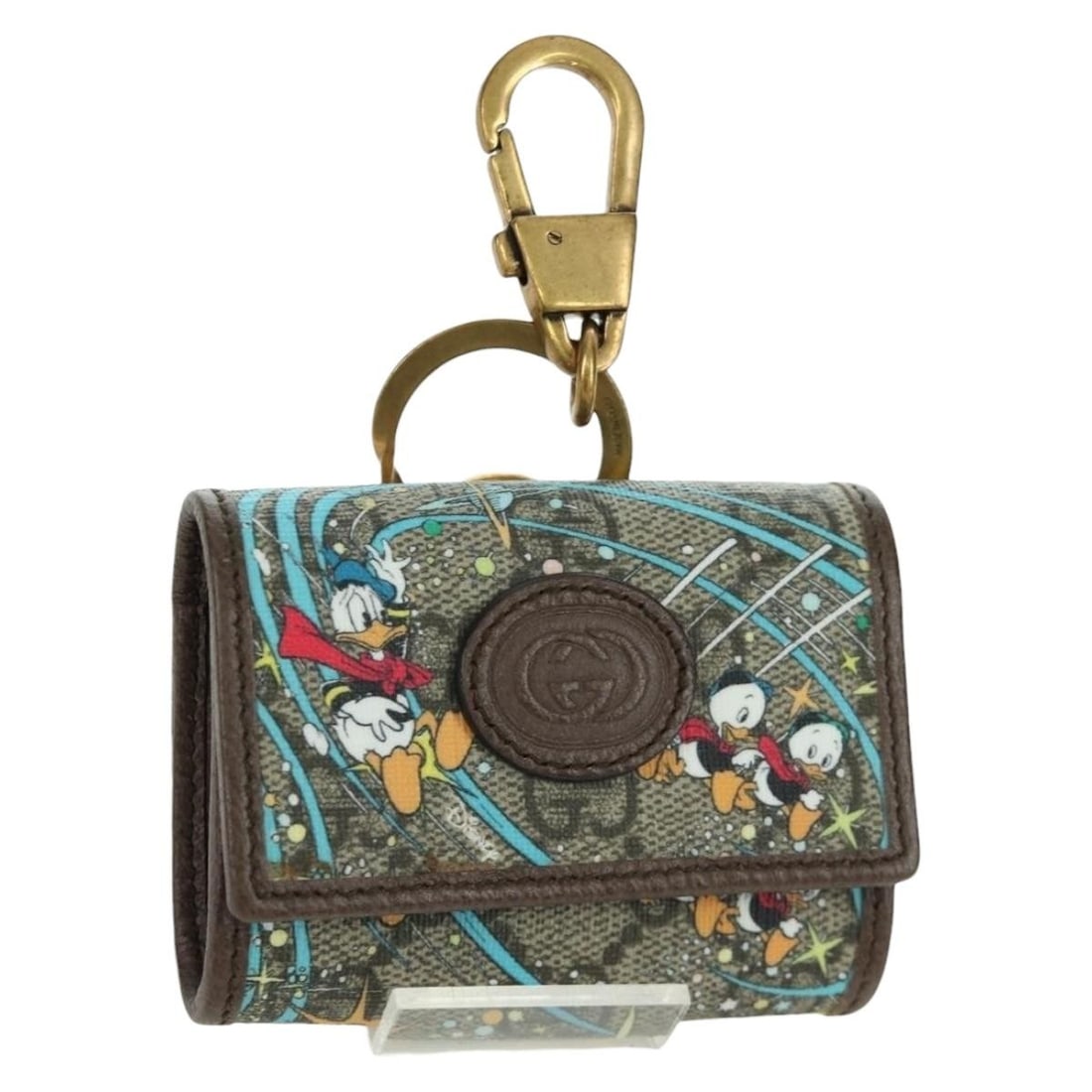 Gucci Disney Donald Duck Beige Gold Charm PVC Leather Bag Accessory: Gucci Disney Donald Duck Beige Gold Charm PVC Leather Bag Accessory This Gucci x Disney Donald Charm features a beige and gold color scheme crafted from PVC leather and GG canvas. Designed as a stylis