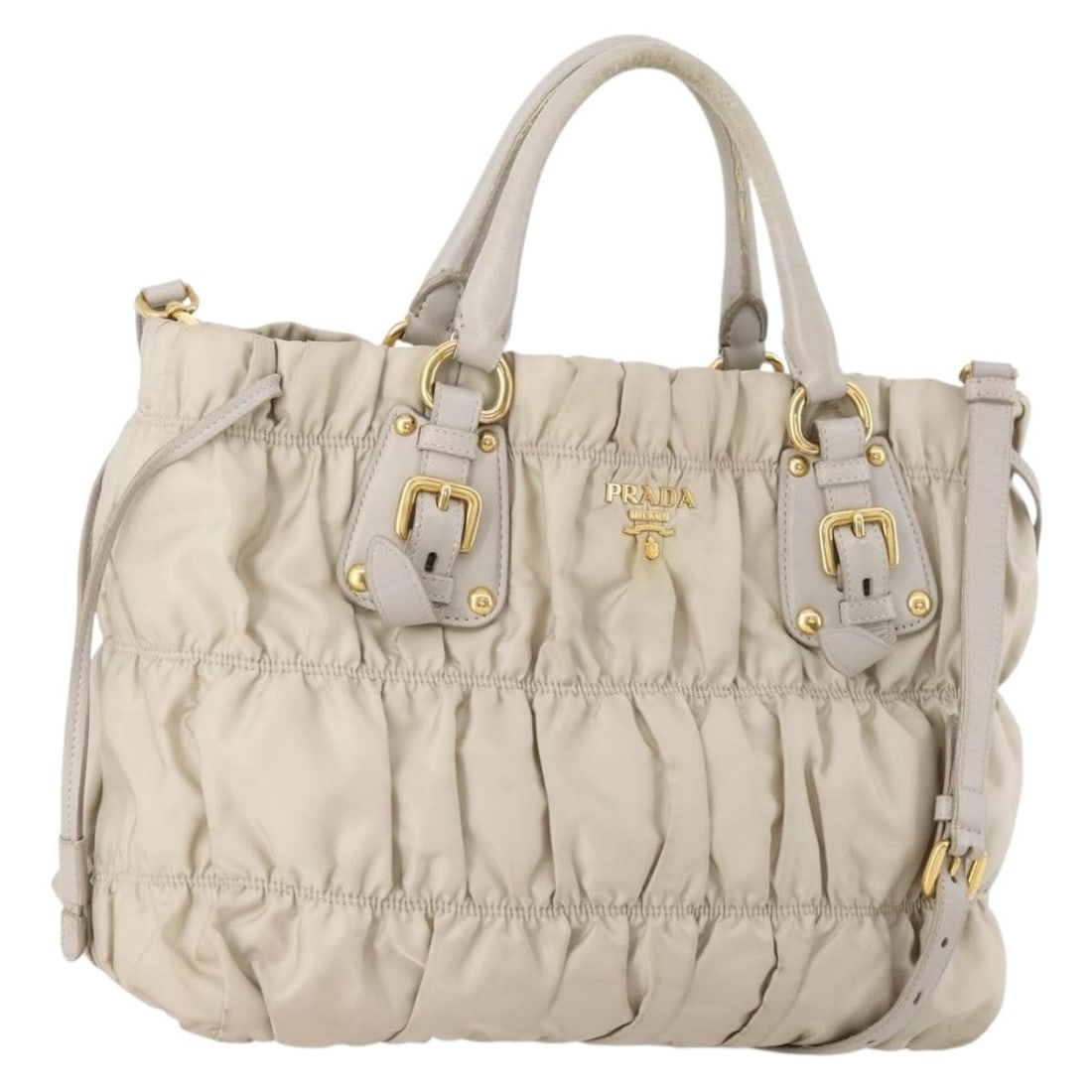 Prada Ivory Nylon Tote with Detachable Shoulder Strap and Gold Accents: Prada Ivory Nylon Tote with Detachable Shoulder Strap and Gold Accents This PRADA tote bag features a 2-way design and is crafted from ivory nylon with gold-tone accents. It offers both handles and a