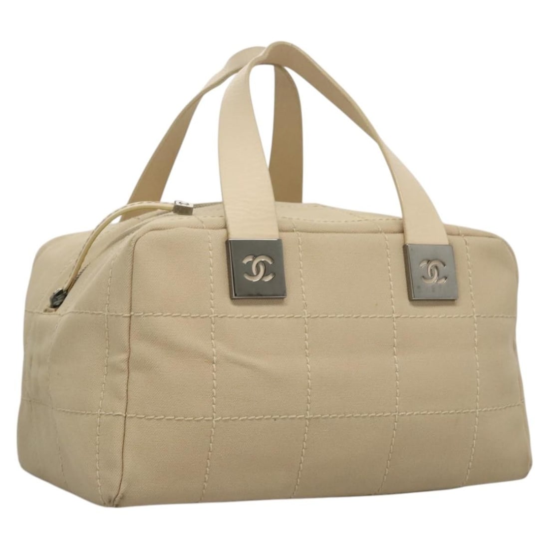 Beige Canvas Choco Bar Handbag by CHANEL with CC Logo and Card: Beige Canvas Choco Bar Handbag by CHANEL with CC Logo and Card This CHANEL Choco Bar handbag features a beige canvas exterior and is designed for women. Made in Italy, it offers both style and practic