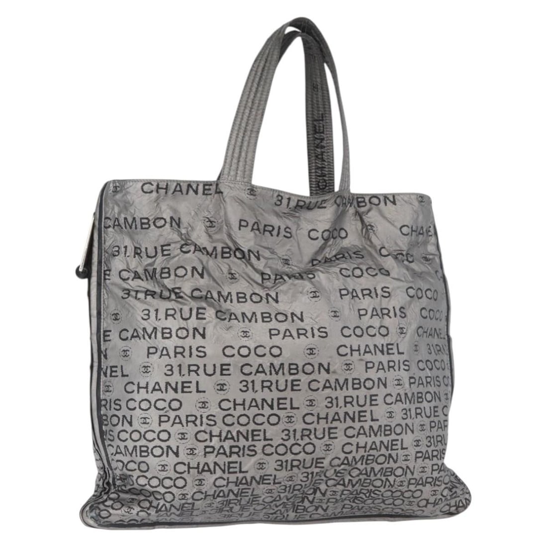 Nylon Silver Tote from CHANEL Unlimited Collection CC Logo Italy: Nylon Silver Tote from CHANEL Unlimited Collection CC Logo Italy This CHANEL Unlimited tote bag features a silver nylon exterior with a classic tote design. The bag offers ample space and is crafted f
