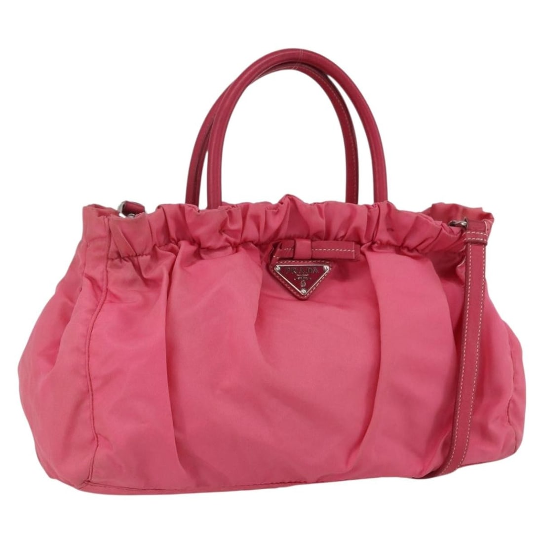 Pink and Gold Prada Nylon Two Way Handbag with Strap and Guarantee Card: Pink and Gold Prada Nylon Two Way Handbag with Strap and Guarantee Card This PRADA handbag features a 2-way design crafted from pink and gold nylon. Made in Italy, it offers both top handles and a det