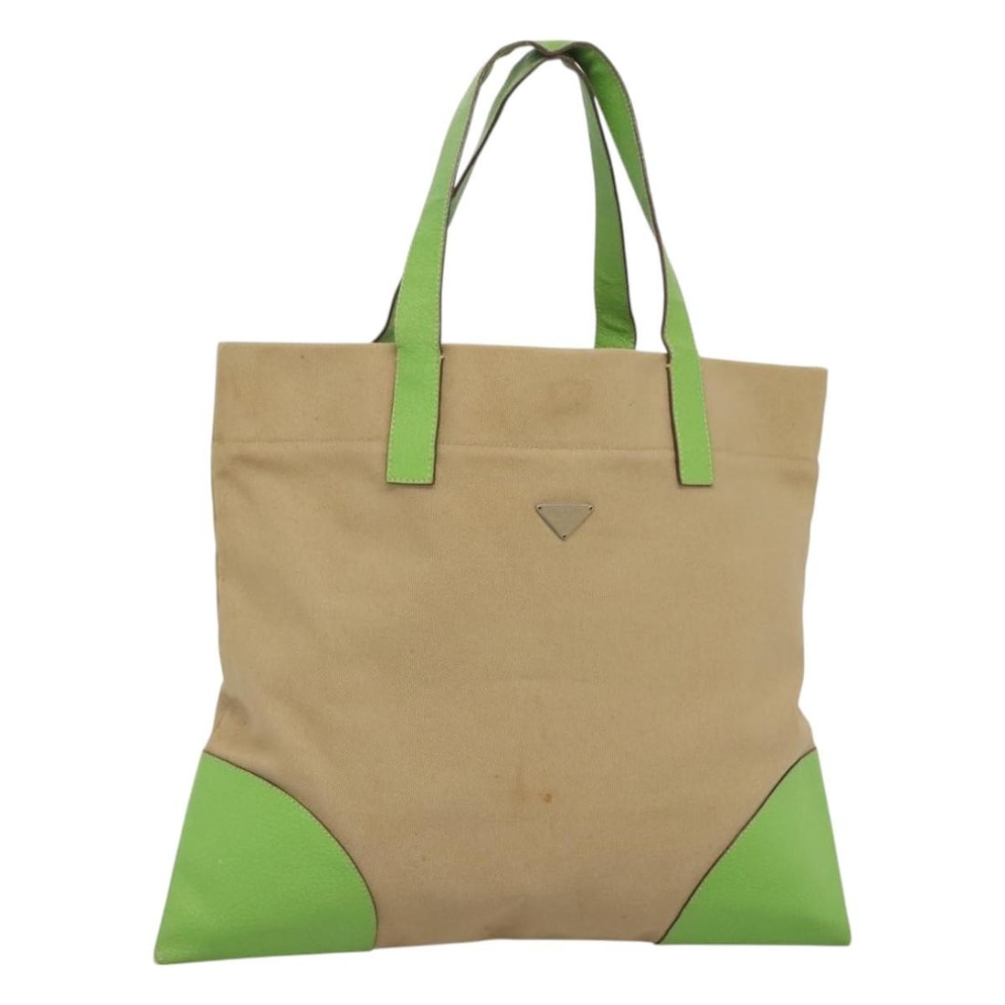 Prada Canvas Tote in Beige and Silver Made in Italy: Prada Canvas Tote in Beige and Silver Made in Italy This PRADA tote bag features a beige and silver canvas exterior with a spacious design, crafted in Italy. It is intended for women and offers a hand