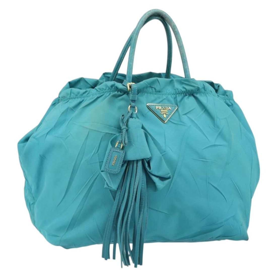 Light Blue Nylon PRADA Handbag with Gold Accents Made in Italy: Light Blue Nylon PRADA Handbag with Gold Accents Made in Italy This PRADA handbag features light blue nylon with gold-tone accents and is made in Italy. The bag has a spacious interior and sturdy hand