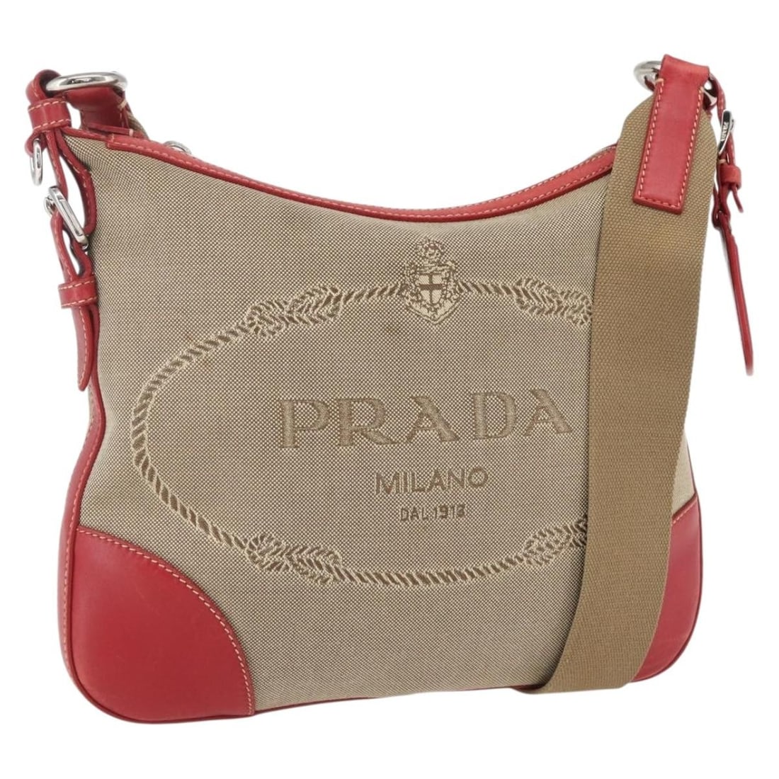 Beige Canvas PRADA Shoulder Purse with Silver Accents Made in Italy: Beige Canvas PRADA Shoulder Purse with Silver Accents Made in Italy This PRADA shoulder bag features a canvas exterior in beige and silver tones. Designed and crafted in Italy, it offers a classic, mi