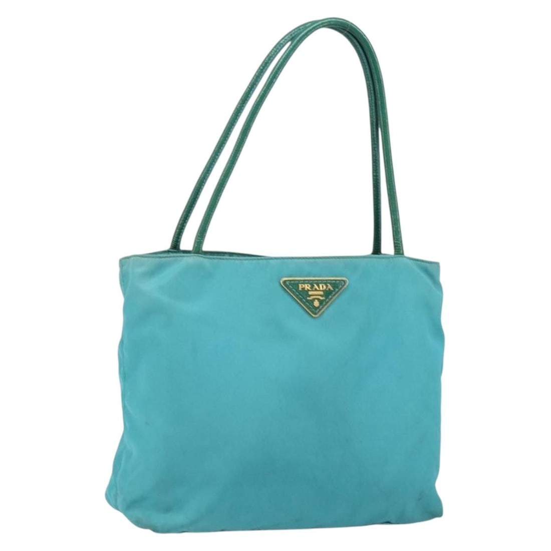 Prada Turquoise Blue Nylon Handbag with Gold Tone Details and Guarantee Card: Prada Turquoise Blue Nylon Handbag with Gold Tone Details and Guarantee Card This Prada hand bag is crafted from turquoise blue nylon with gold-tone accents. Made in Italy, it features a structured de