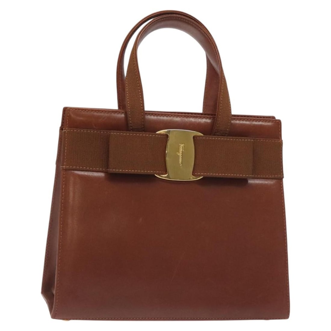 Salvatore Ferragamo Vala Leather Hand Bag Brown Gold Made in Italy: Salvatore Ferragamo Vala Leather Hand Bag Brown Gold Made in Italy The Salvatore Ferragamo Vala Hand Bag is a luxurious accessory crafted from high-quality leather, featuring an elegant combination of