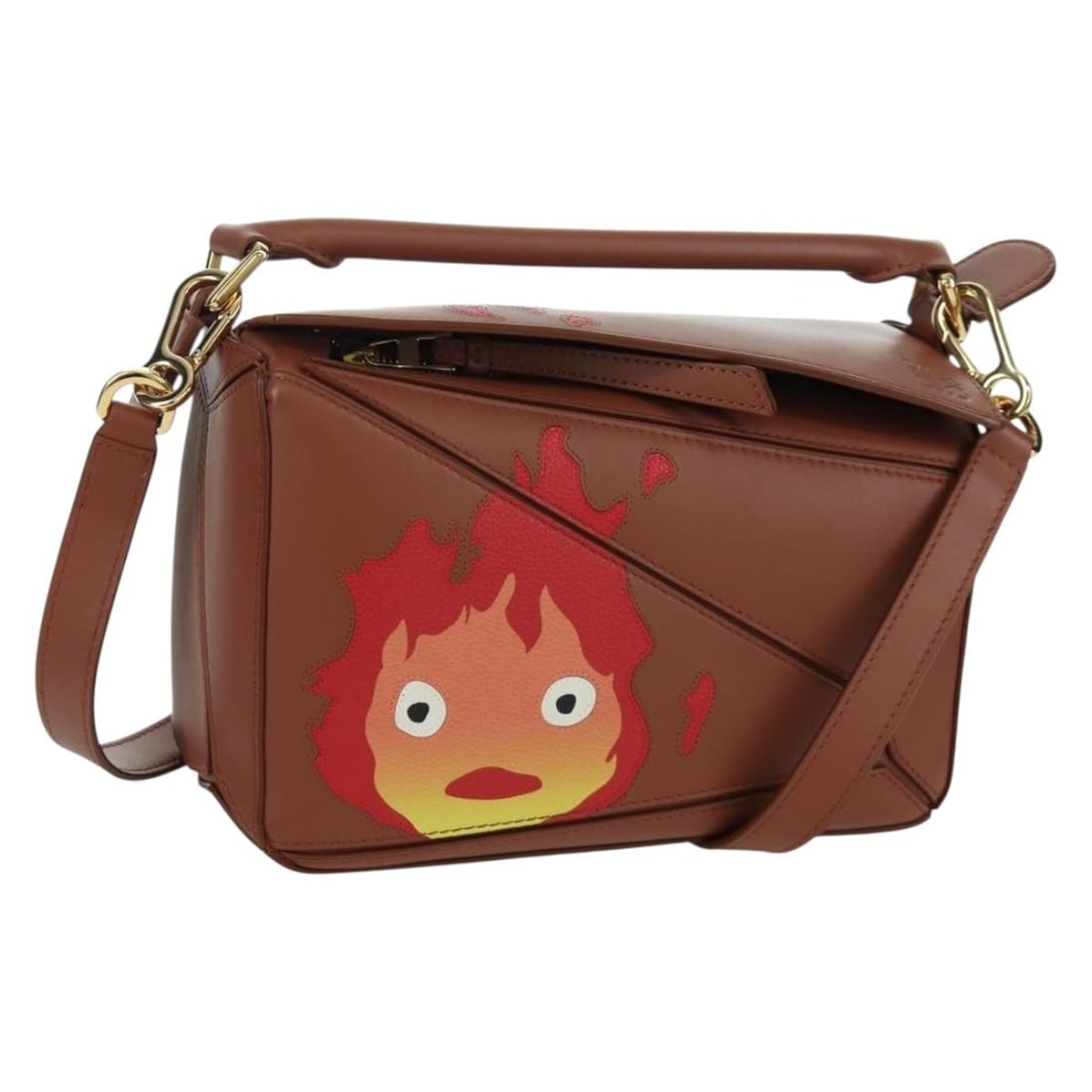 Howl's Moving Castle Calcifer Small Puzzle Brown Leather Handbag by Loewe: Howl's Moving Castle Calcifer Small Puzzle Brown Leather Handbag by Loewe This LOEWE x Ghibli Howl's Moving Castle Puzzle Small Calcifer 2-way handbag is crafted from brown and gold leather and can be