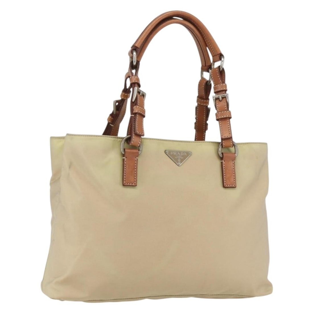 Ivory Nylon Prada Tote Bag with Silver Accents: Ivory Nylon Prada Tote Bag with Silver Accents This PRADA tote bag is crafted from ivory nylon with silver-tone accents. The bag features a spacious interior, dual handles, and is made in Italy. Pleas