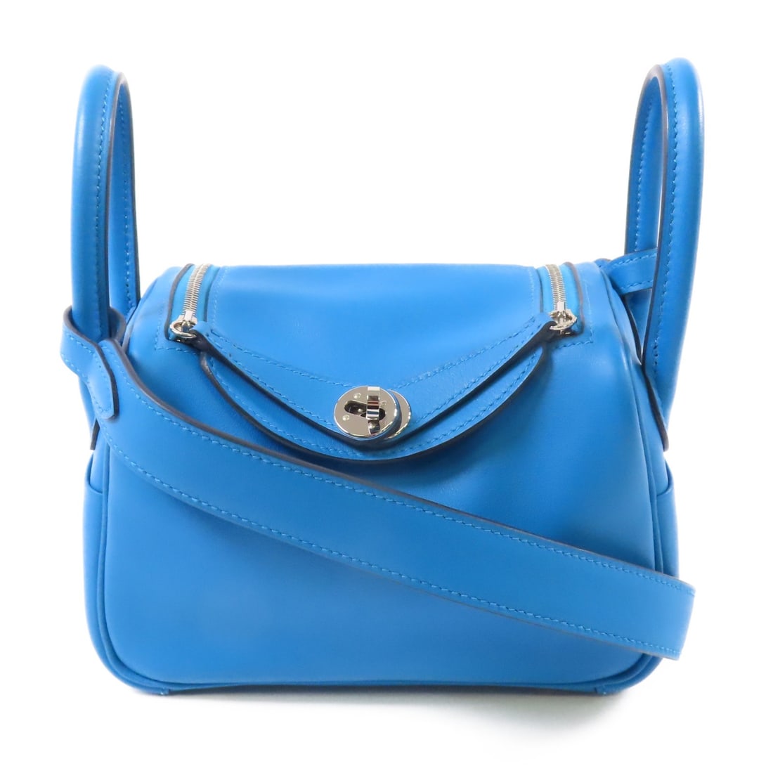 HERMES Mini Lindy 2Way Shoulder Bag Veau Swift Blue PHW: HERMES Mini Lindy 2Way Shoulder Bag Veau Swift Blue PHW This elegant HERMES Mini Lindy 2Way Shoulder Hand Bag is crafted from premium calfskin, showcasing a stunning blue exterior. Designed for versat