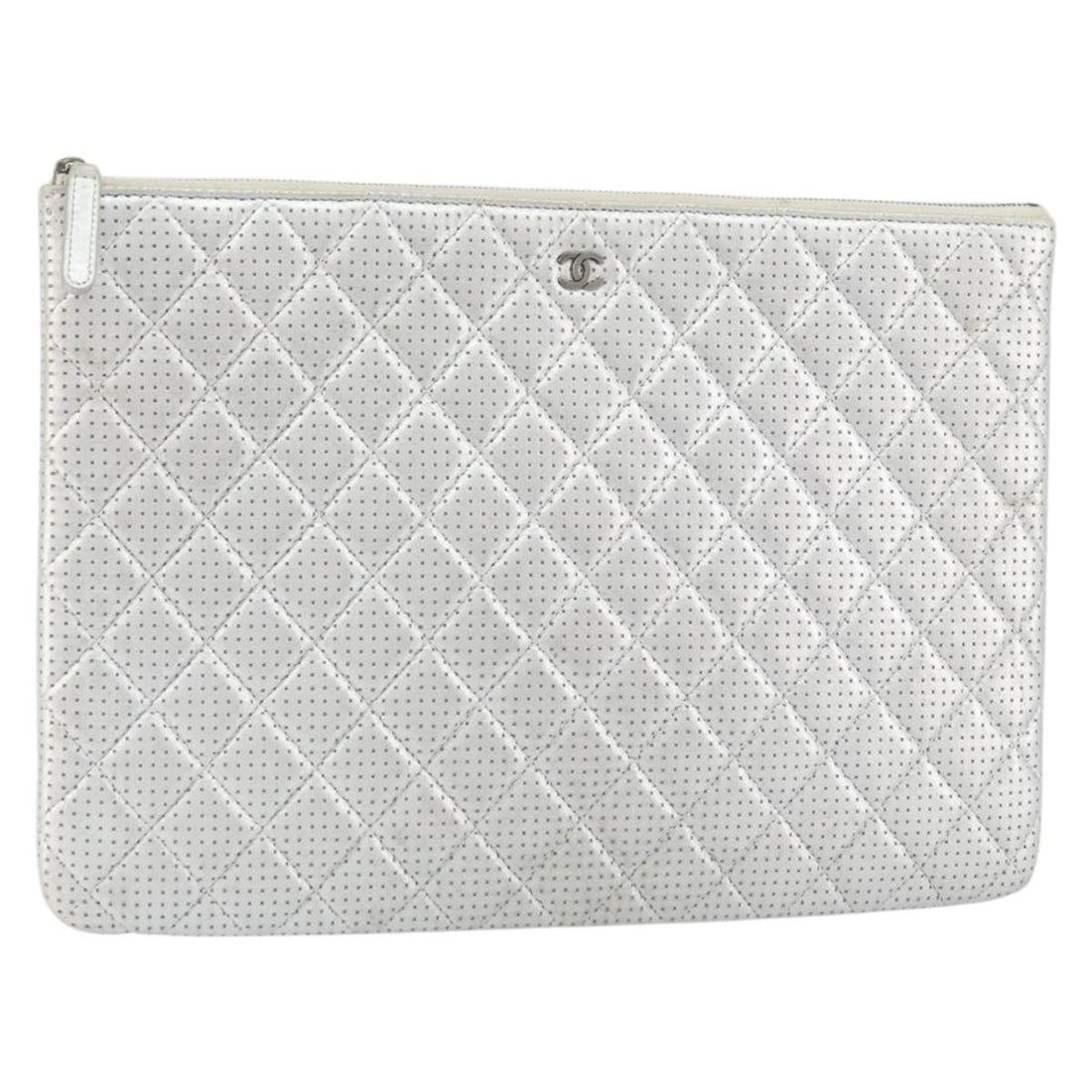 CHANEL Silver Leather Matelasse Punching Clutch Bag with CC Logo: CHANEL Silver Leather Matelasse Punching Clutch Bag with CC Logo This CHANEL Matelasse Punching clutch bag features a silver leather exterior with the iconic CC logo. Designed as a clutch, it is craft