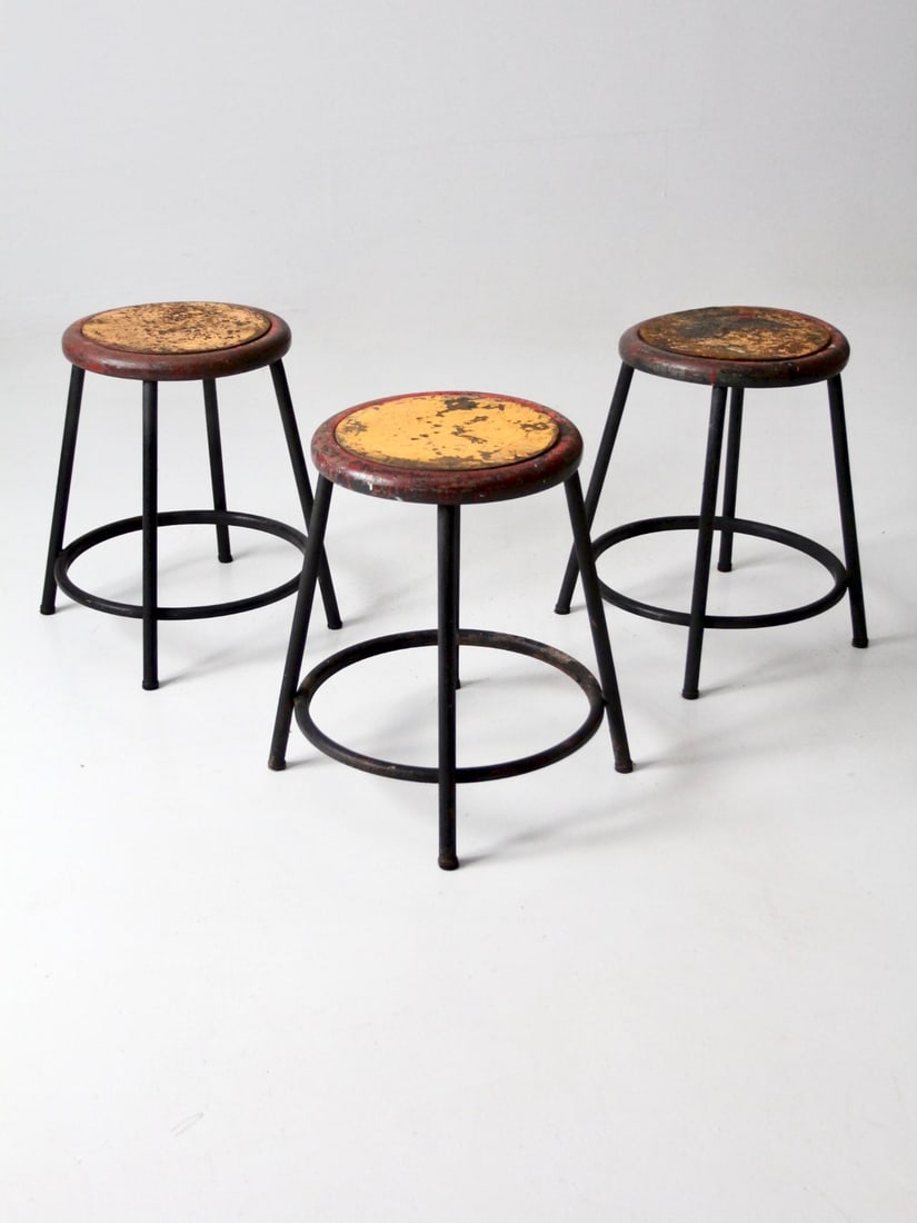 Vintage Industrial Stools Set of 3 Retro Red Yellow Design: Vintage Industrial Stools Set of 3 Retro Red Yellow Design This set of three vintage industrial stools showcases a striking design with black metal frames and vibrant red and yellow seats, perfect for