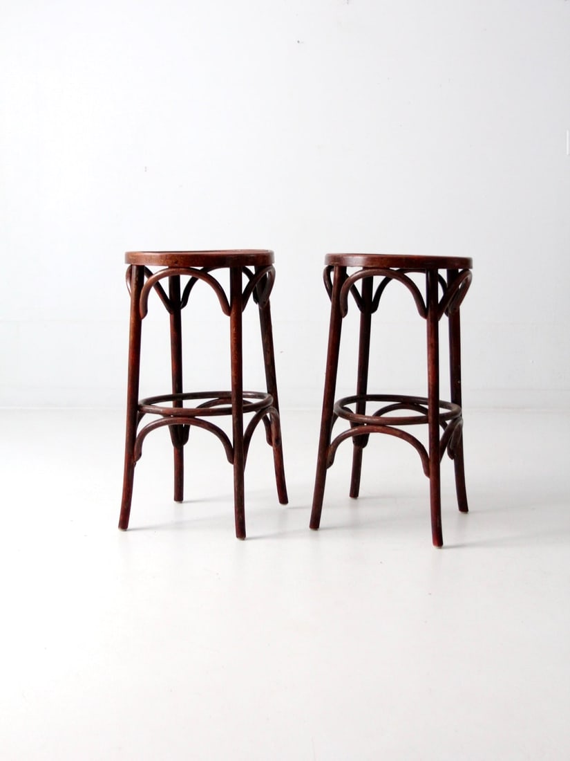 Pair of Early 20th Century Bentwood Bar Stools With Round Seats: Pair of Early 20th Century Bentwood Bar Stools With Round Seats This pair of early 20th century bentwood stools features round seats and continuous curved supports that create a rhythmic, architectura