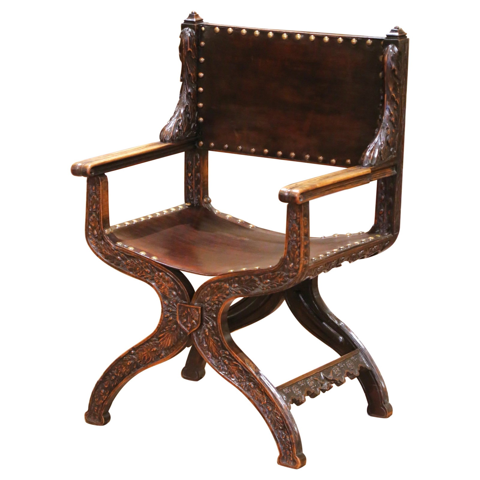19th Century French Dagobert Curule Armchair in Walnut and Tooled Leather: 19th Century French Dagobert Curule Armchair in Walnut and Tooled Leather This exquisite 19th-century French armchair exemplifies the curule or "Dagobert" style, drawing inspiration from early medieva