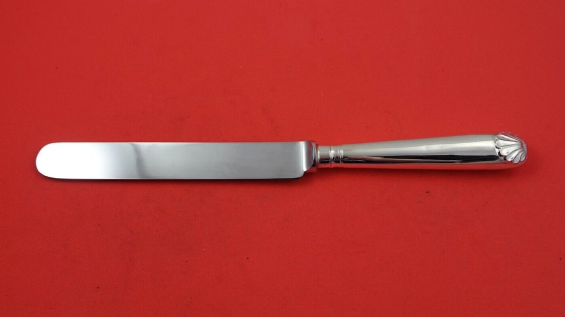 James Robinson Shell Sterling Silver Dinner Knife 9 7/8 Inch: James Robinson Shell Sterling Silver Dinner Knife 9 7/8 Inch Introducing the exquisite Shell dinner knife by James Robinson, crafted in high-quality sterling silver. This pre-owned piece features a ho