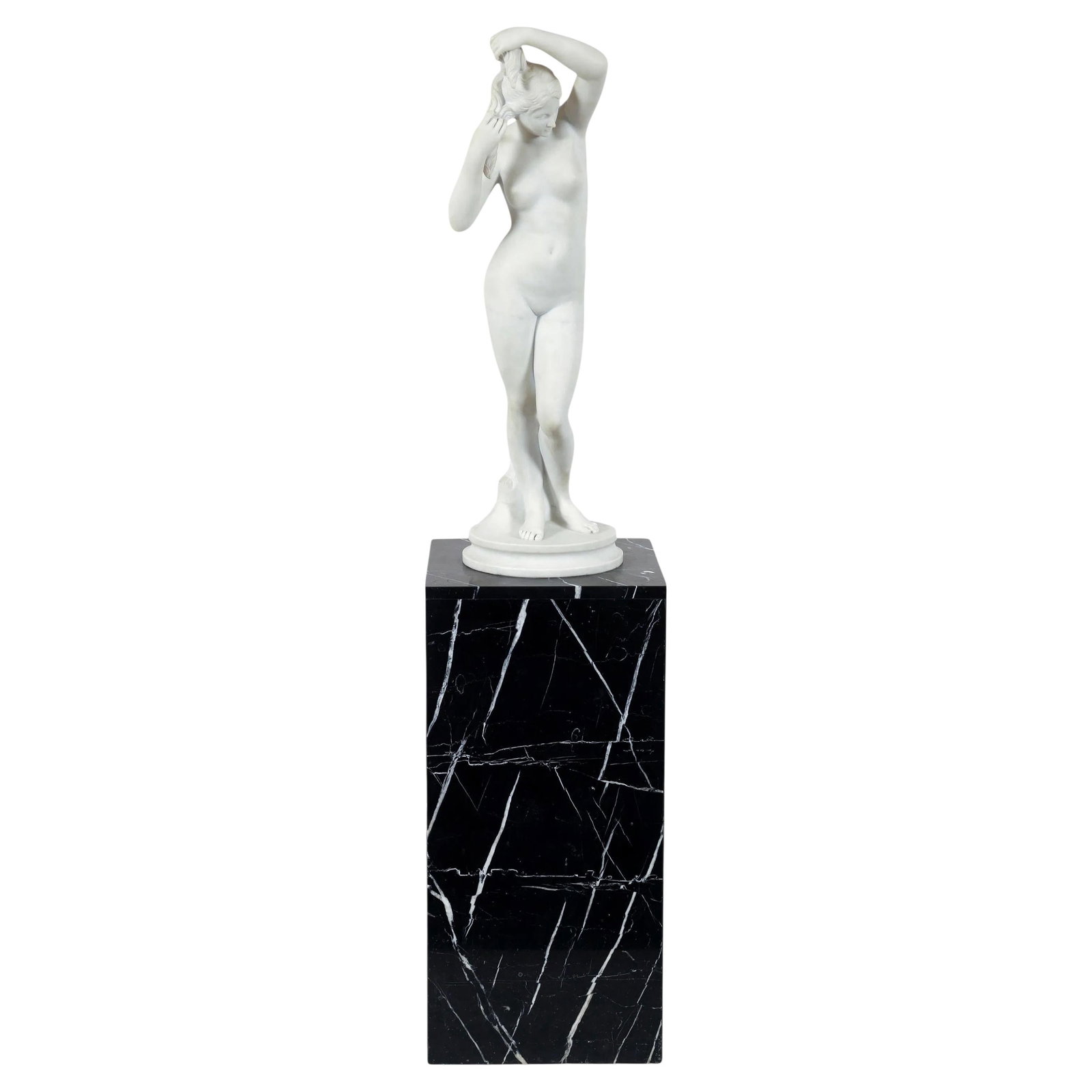 Neoclassical Marble Nude Sculpture on Charcoal Pedestal 62 Inch Height: Neoclassical Marble Nude Sculpture on Charcoal Pedestal 62 Inch Height This neoclassical white marble statue features a classical standing nude beauty, possibly depicting Venus, in her bath. The statu