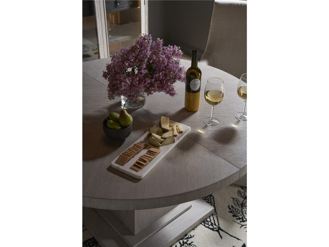 Universal Rasmus Round Dining Table with Extendable Leaf in Rolling Fog: Universal Rasmus Round Dining Table with Extendable Leaf in Rolling Fog Introducing the Extendable Rasmus Round Dining Table, a perfect blend of timeless elegance and functionality. This exquisite din