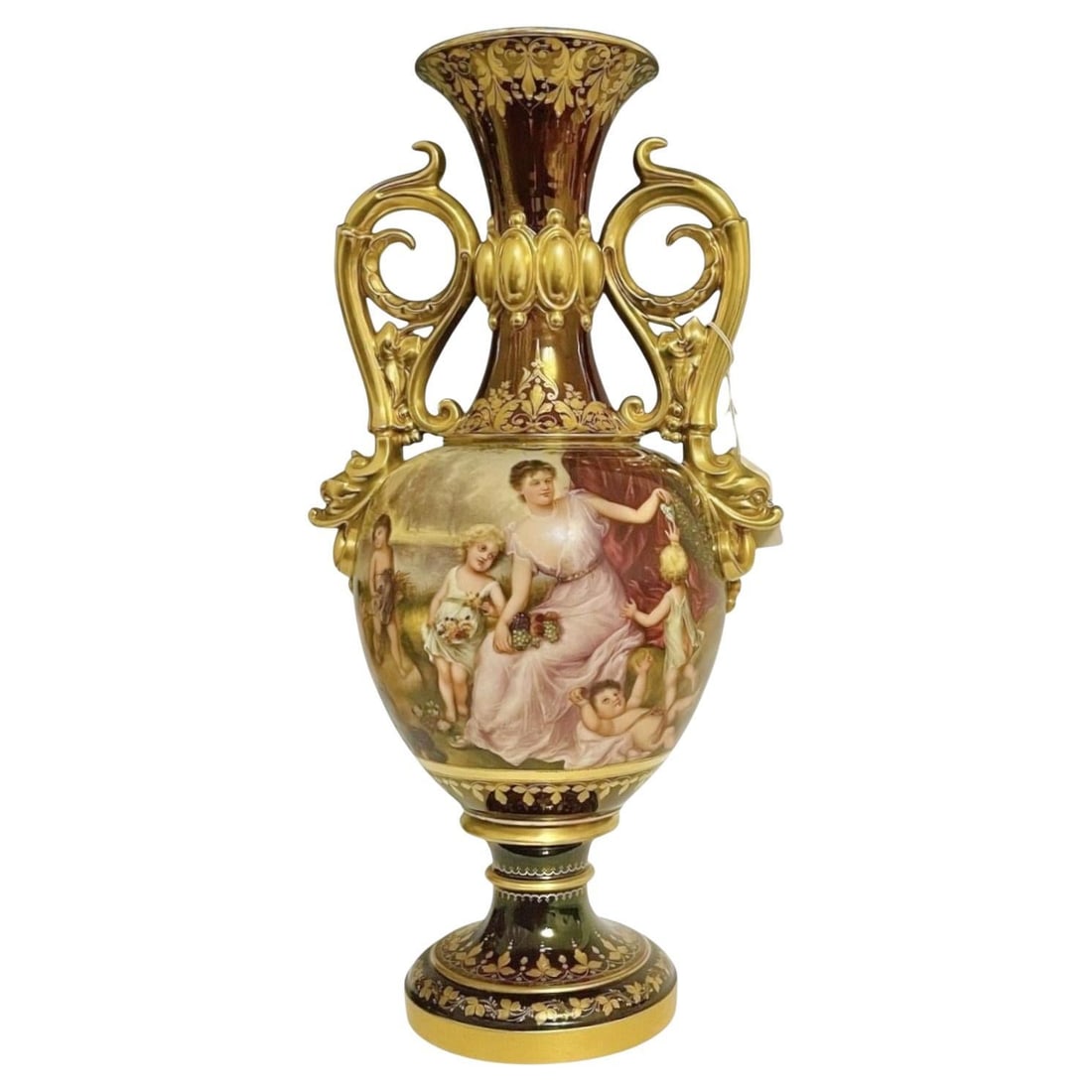 Hand-Painted Porcelain Vase Signed Wagner with Autumn Scene and Gilt Decoration: Hand-Painted Porcelain Vase Signed Wagner with Autumn Scene and Gilt Decoration This Royal Vienna style porcelain vase, crafted in Austria circa 1900, features extensive gilt decorations over a burgun