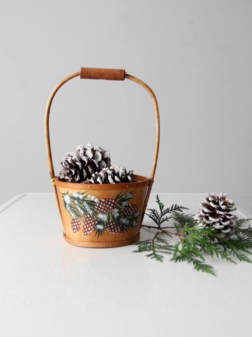 Vintage Hand-Painted Balsa Wood Basket with Bentwood Handle: Vintage Hand-Painted Balsa Wood Basket with Bentwood Handle Embrace the charm of yesteryear with this stunning vintage hand-painted balsa wood basket. Adorned with hand-painted winter pinecones, this
