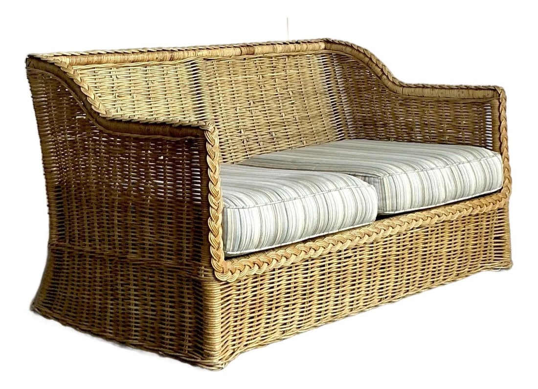 1970s Braided Rattan Coastal Loveseat With Original Striped Cushions: 1970s Braided Rattan Coastal Loveseat With Original Striped Cushions This vintage coastal braided rattan loveseat features handcrafted braided rattan construction, offering an organic texture and warm
