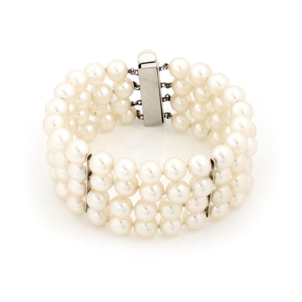 14k White Gold 4 Strand Pearl Bracelet with Slide Clasp: 14k White Gold 4 Strand Pearl Bracelet with Slide Clasp This exquisite vintage bracelet is designed with 14k white gold and showcases four strands of lustrous pearls, elegantly divided by four slender