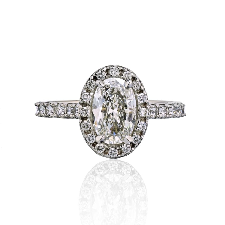 1.19ct GIA Oval Diamond Halo Engagement Ring in 18K White Gold: 1.19ct GIA Oval Diamond Halo Engagement Ring in 18K White Gold This exquisite engagement ring features a stunning 1.19 carat oval diamond at its center, graded F color and VVS1 clarity by GIA. Set in 