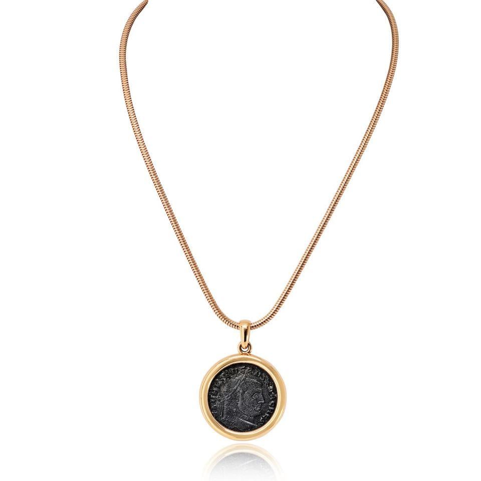 Monete Necklace in 18K Yellow Gold with Carthaginian Severus Coin by Bvlgari: Monete Necklace in 18K Yellow Gold with Carthaginian Severus Coin by Bvlgari This Bvlgari Monete necklace features a bold and sophisticated design, crafted from 18K yellow gold and centered with an au