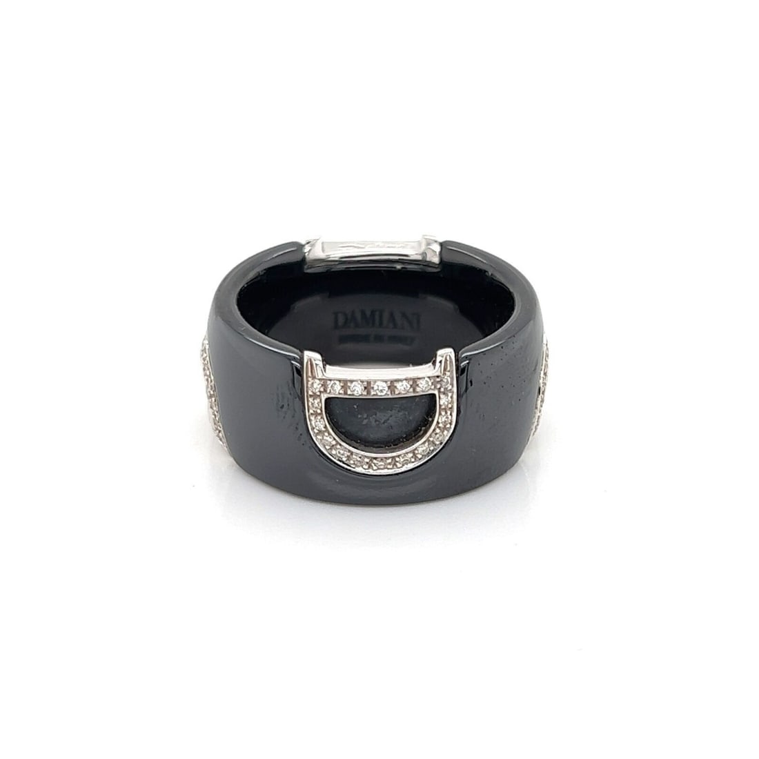 Damiani D Logo 18k White Gold Black Ceramic Diamond Band Ring Size 6: Damiani D Logo 18k White Gold Black Ceramic Diamond Band Ring Size 6 This Damiani D Logo band ring combines 18k white gold and black ceramic in a bold, contemporary design. The 10mm wide band features