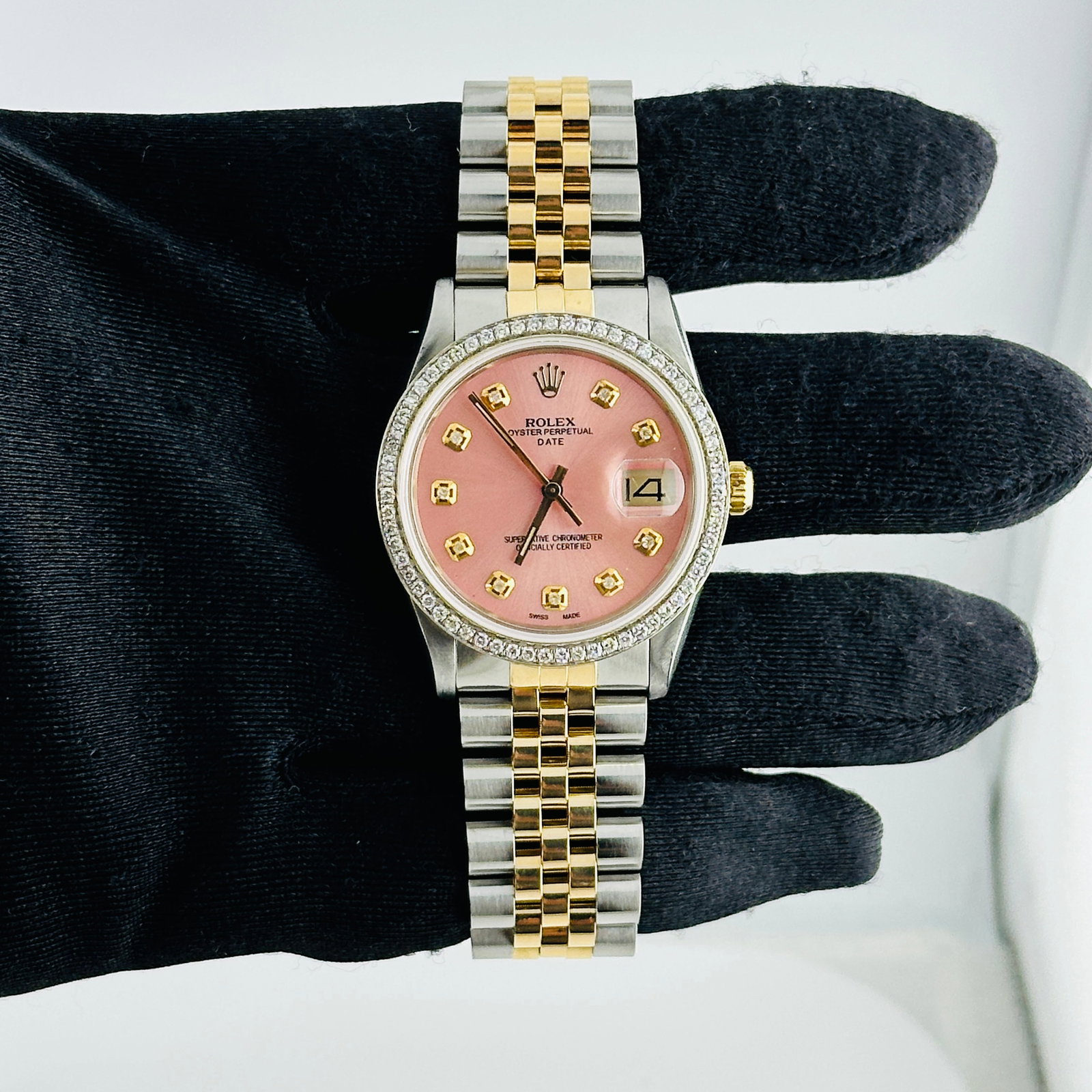 Oyster Perpetual Date Ref 15053 Aftermarket Pink Diamond Dial D Link Jubilee: Oyster Perpetual Date Ref 15053 Aftermarket Pink Diamond Dial D Link Jubilee This Rolex Oyster Perpetual Date watch features an Aftermarket pink diamond dial and a pave 10K diamond bezel. It is paired