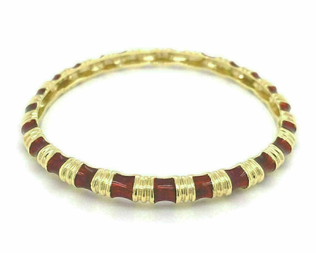 Red Enamel and 18k Yellow Gold Wide Bangle Bracelet by Tiffany & Co.: Red Enamel and 18k Yellow Gold Wide Bangle Bracelet by Tiffany & Co. This vintage Tiffany & Co. wide bangle bracelet features vibrant red enamel set in 18k yellow gold. The bracelet is signed for auth