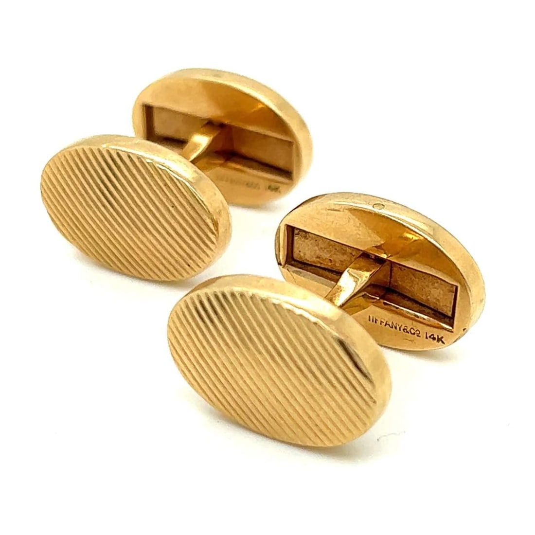 Tiffany & Co. Signed 14K Yellow Gold Cufflinks: Tiffany & Co. Signed 14K Yellow Gold Cufflinks These exquisite Tiffany & Co. cufflinks are crafted in 14K yellow gold, offering a luxurious touch to any formal attire. Weighing 27.9 grams, they featur