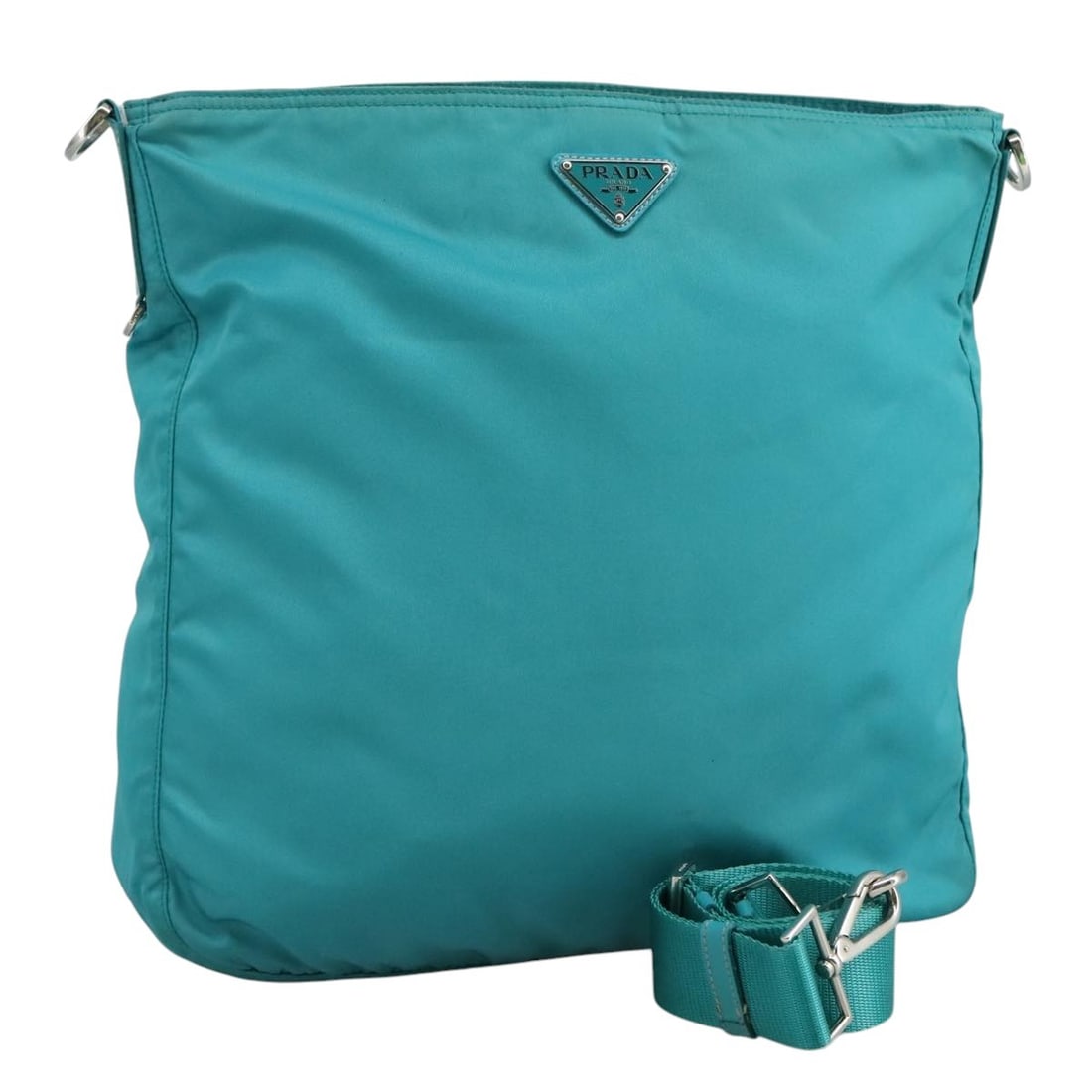 Prada Tessuto Nylon Messenger Bag Turquoise Zip Closure: Prada Tessuto Nylon Messenger Bag Turquoise Zip Closure This pre-owned Prada Zip Top Messenger Bag for women features a turquoise nylon exterior with signs of wear including surface rubbing, stains, a