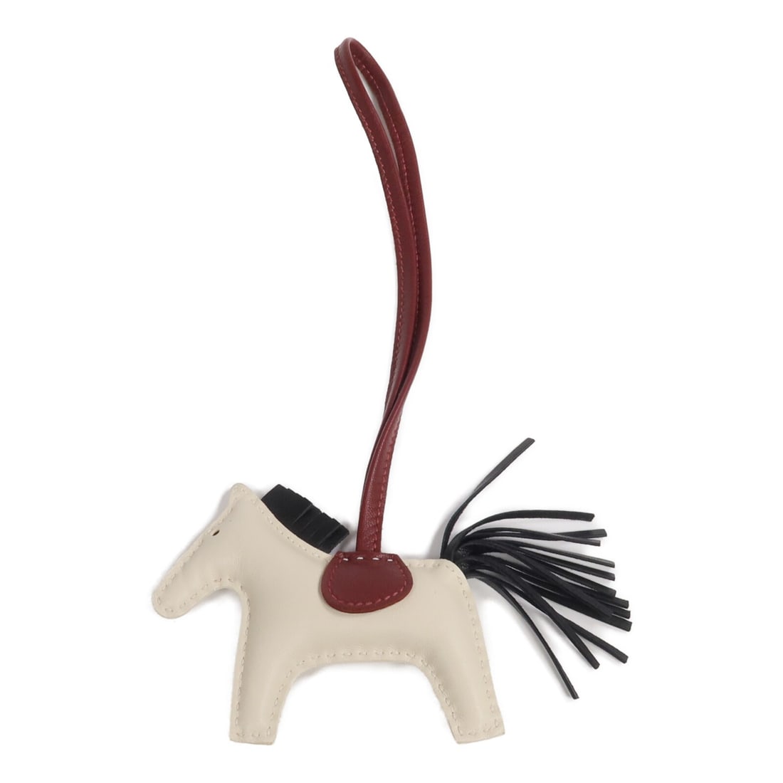 Hermes Rodeo PM Lambskin Bag Charm in White Black and Red: Hermes Rodeo PM Lambskin Bag Charm in White Black and Red This Hermes Rodeo PM charm is crafted from soft Milo lambskin leather in a combination of Craie (white), Noir (black), and Rouge H (red) color