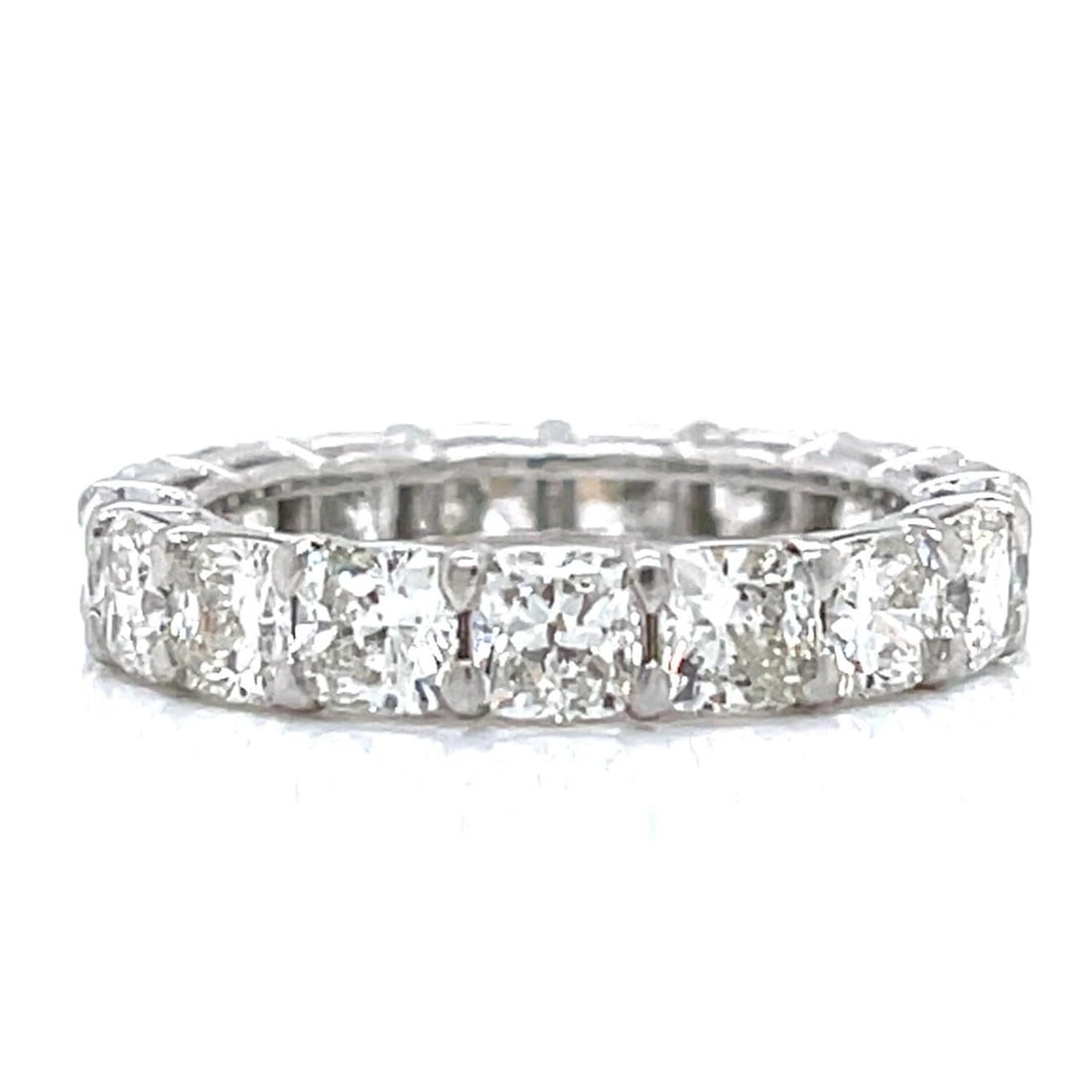 Platinum Eternity Band 5.00 Ct Cushion-cut Diamonds Size 5: Platinum Eternity Band 5.00 Ct Cushion-cut Diamonds Size 5 This exquisite platinum eternity band features 17 stunning cushion-cut diamonds, totaling approximately 5.00 carats. The diamonds exhibit a b