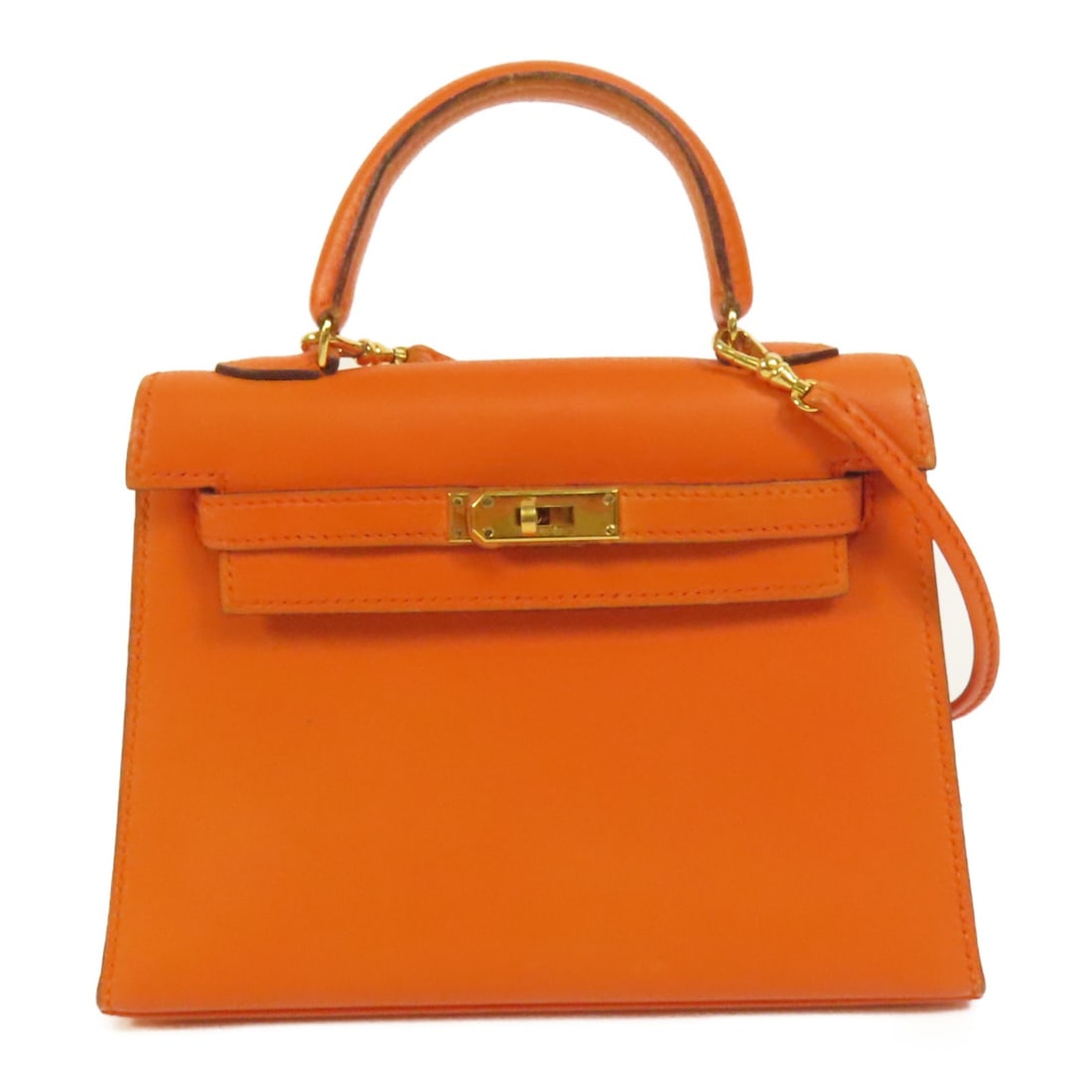 HERMES Kelly 25 2way Shoulder Bag Orange Swift Leather GHW: HERMES Kelly 25 2way Shoulder Bag Orange Swift Leather GHW This exquisite HERMES Kelly 25 2way Shoulder Bag is beautifully crafted from high-quality calfskin leather in a vibrant orange hue. Ideal for