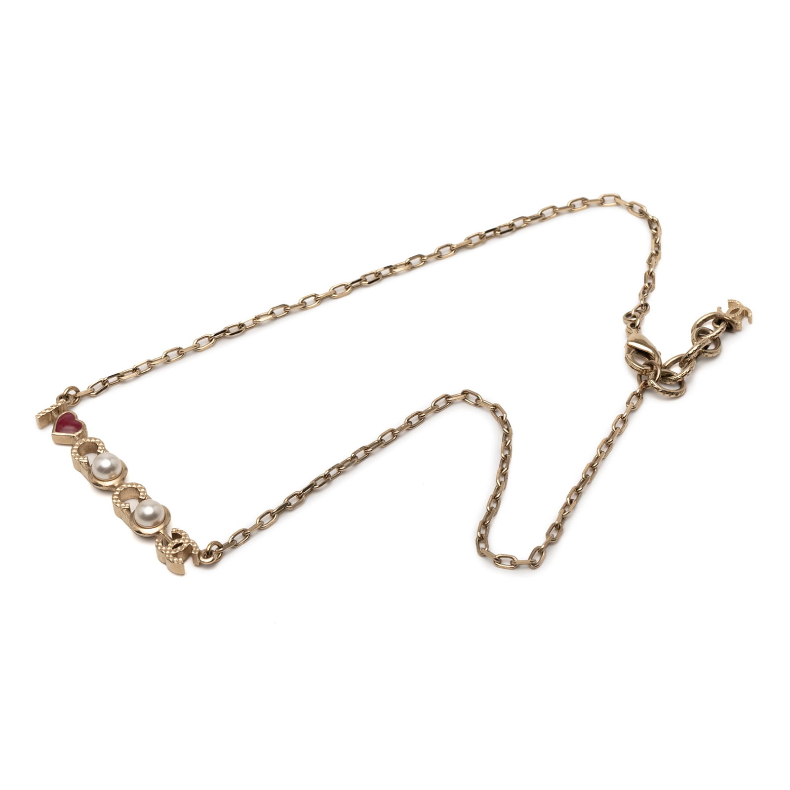 Chanel I Love You Coco Gold Plated Faux Pearl Pendant Necklace: Chanel I Love You Coco Gold Plated Faux Pearl Pendant Necklace This exquisite Chanel necklace showcases a striking gold-plated metal body complemented by a gold tone chain. Adorned with a charming 'I 