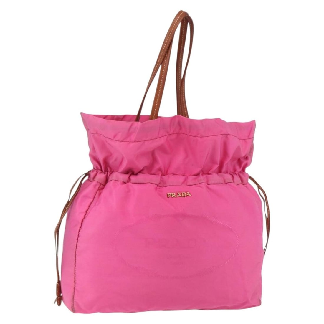 Pink Nylon Prada Tote Bag with Logo Drawstring Closure: Pink Nylon Prada Tote Bag with Logo Drawstring Closure This pre-owned Prada Logo Drawstring Tote for women features a pink nylon exterior with leather accents. It has a drawstring closure and metal fi