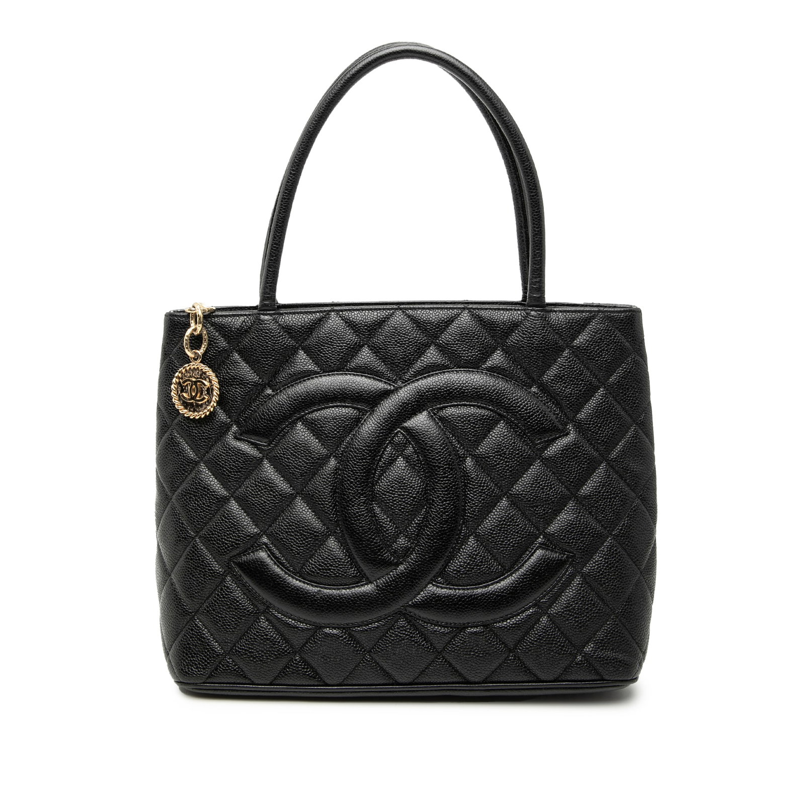 Black Caviar Leather Quilted Medallion Tote Bag by Chanel: Black Caviar Leather Quilted Medallion Tote Bag by Chanel This Chanel Medallion Tote features a quilted caviar leather exterior in black, rolled leather handles, a top zip closure, an exterior back sl