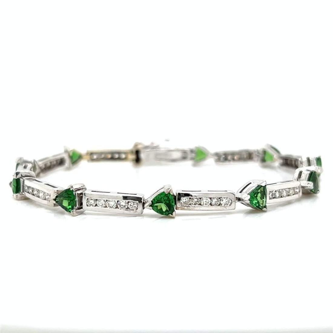 Elegant 14K White Gold Tsavorite Garnet and Diamond Bracelet: Elegant 14K White Gold Tsavorite Garnet and Diamond Bracelet This exquisite 14K White Gold bracelet features a stunning combination of Tsavorite garnets and diamonds. The bracelet weighs 15.3 grams an