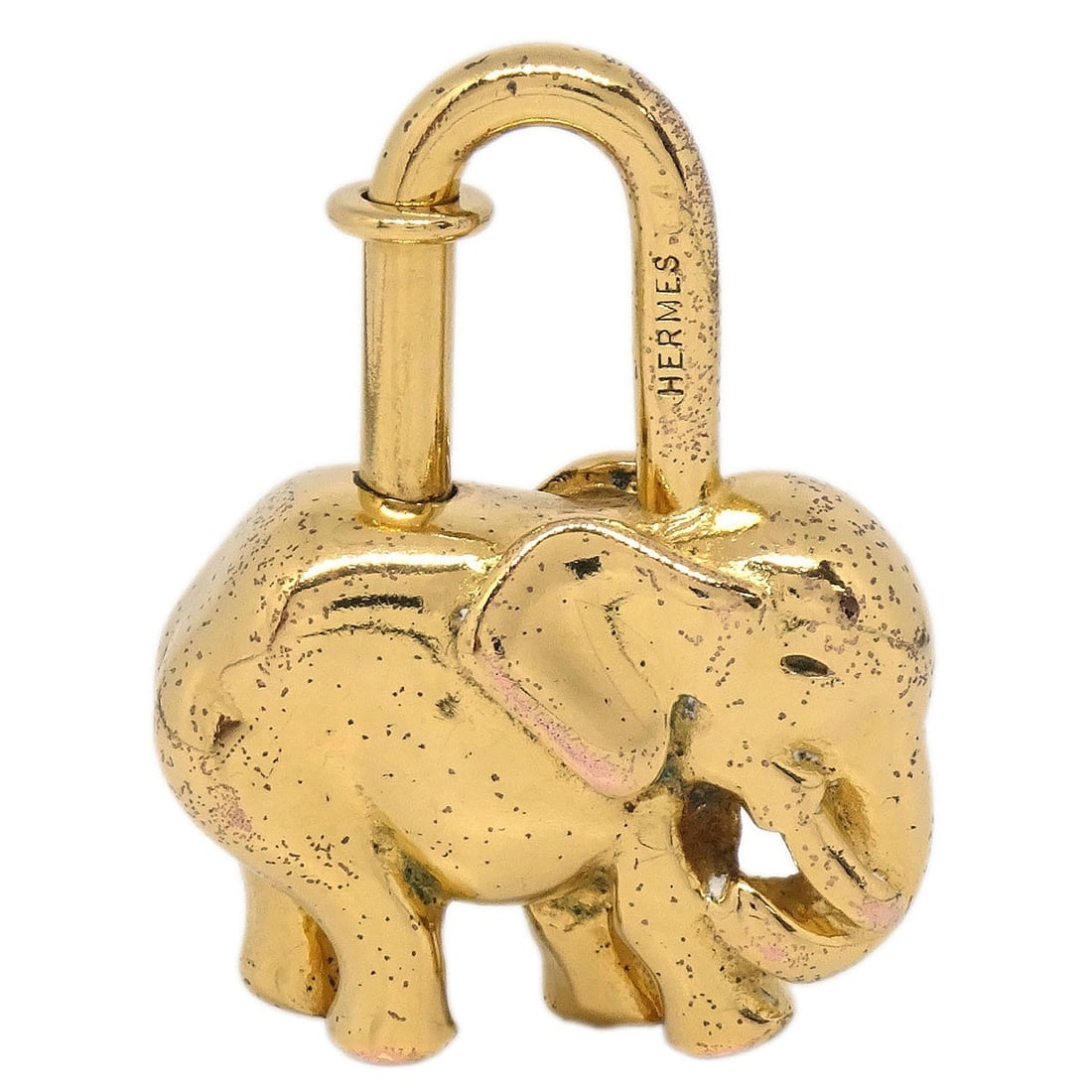 Hermes Elephant Cadena Vintage Gold Tone Unisex Charm 1988: Hermes Elephant Cadena Vintage Gold Tone Unisex Charm 1988 This is a vintage Hermes charm from 1988, designed in the shape of an elephant and finished in gold tone. Made in France, this collectible pi