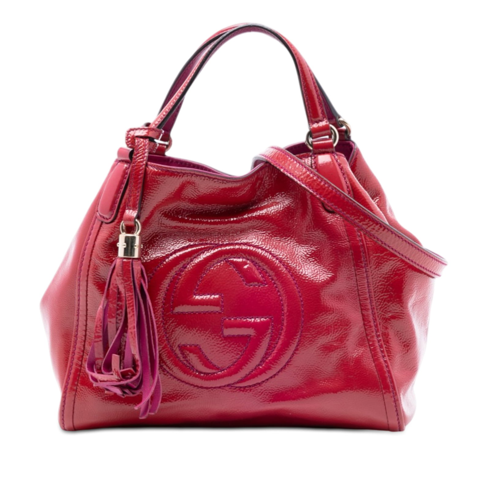 Red Patent Leather Soho Satchel with Tassel and Strap by Gucci: Red Patent Leather Soho Satchel with Tassel and Strap by Gucci This Gucci Small Patent Soho Satchel features a red patent leather body with flat leather handles accented by tassel details and a detach