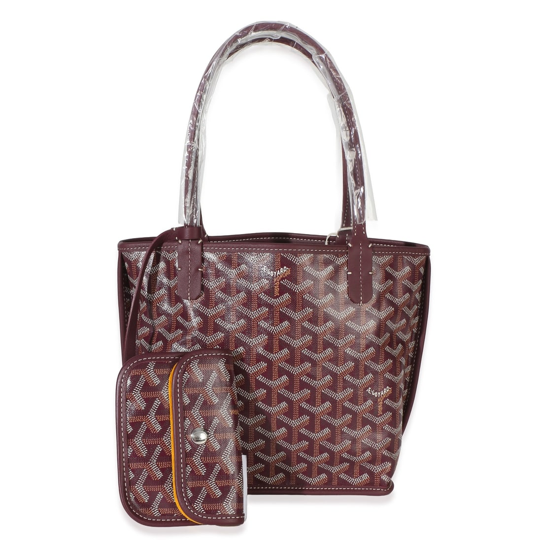 Mini Anjou tote in burgundy Goyardine canvas with accessories: Mini Anjou tote in burgundy Goyardine canvas with accessories This Goyard Burgundy Goyardine Canvas Mini Anjou is a pre-owned, unisex tote crafted in France from signature red Goyardine canvas with ca