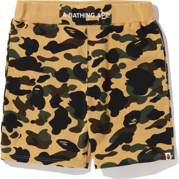 Yellow and Silver 1st Camo Sweatshorts by A Bathing Ape Medium: Yellow and Silver 1st Camo Sweatshorts by A Bathing Ape Medium These sweatshorts feature the iconic BAPE 1st Camo pattern in yellow with silver accent detailing. Made from premium cotton fleece, they 